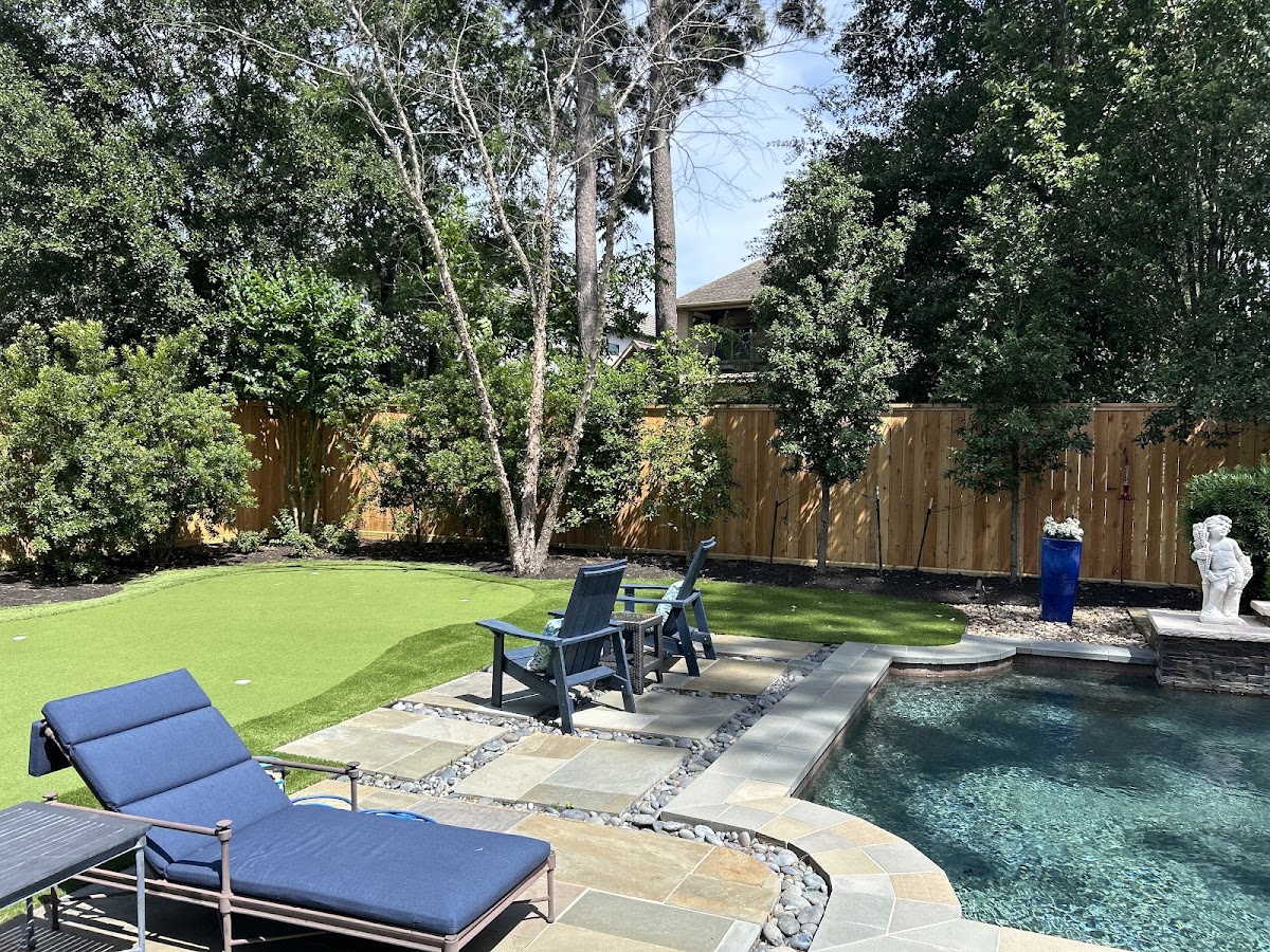 Backyard oasis with new cedar fence, pool, and putting green